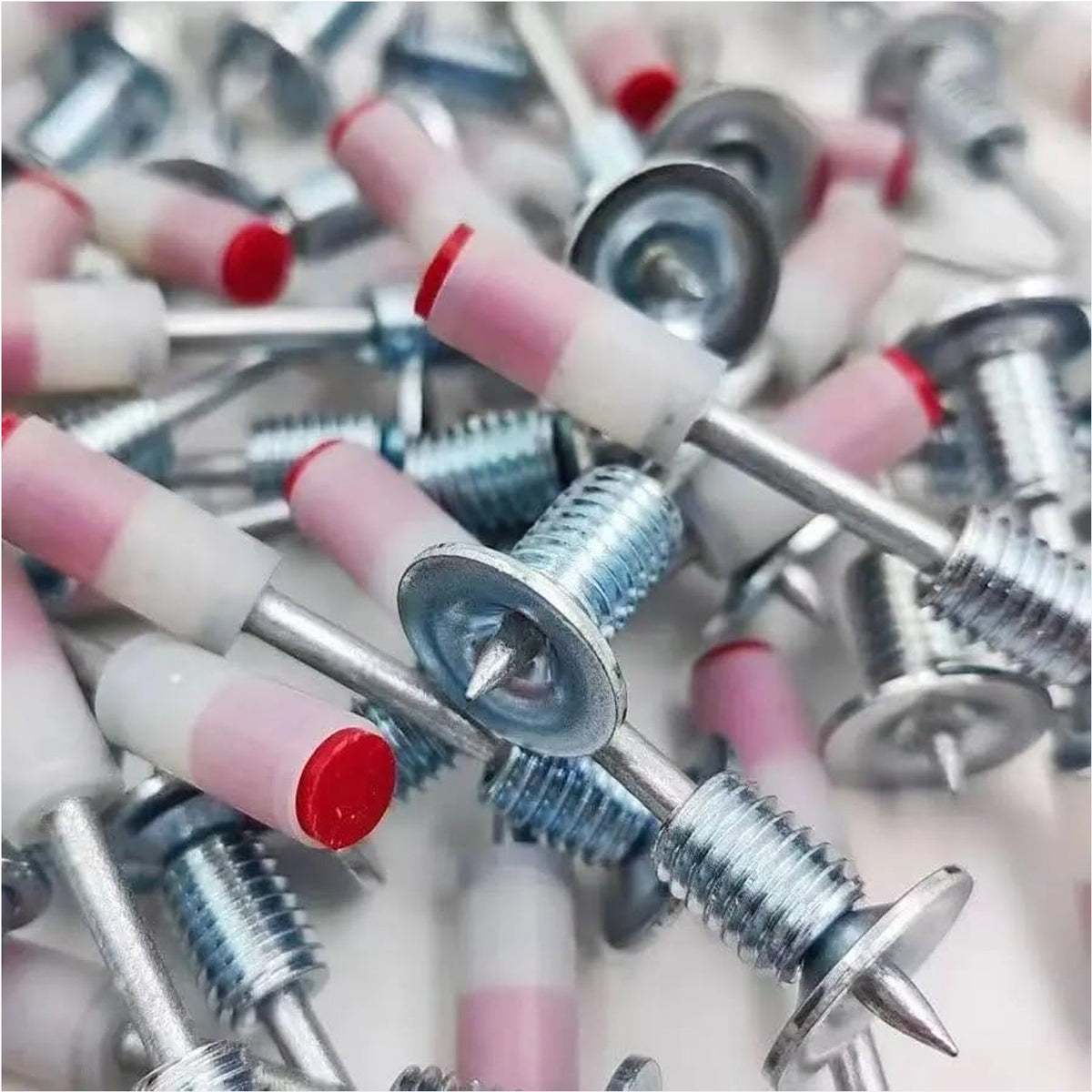Stack of 100 steel nail gun nails ready for efficient use